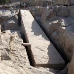 L'obelisco incompiuto di Assuan ancora attaccato alla roccia nella trincea scavata intorno, con le tracce di lavorazione sulla pietra